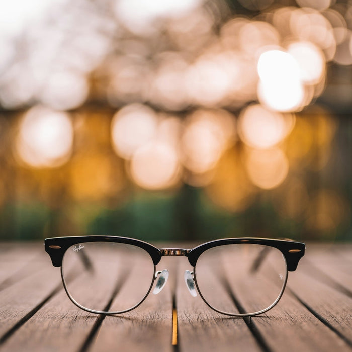 black framed eyeglasses on brown wooden table