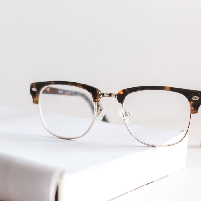 clear eyeglasses on book