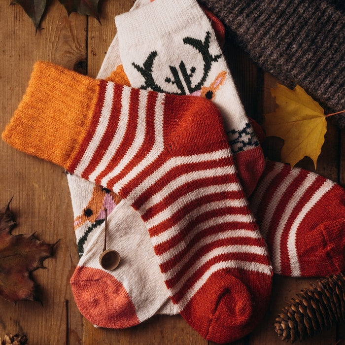 a pair of socks and a hat on a wooden table
