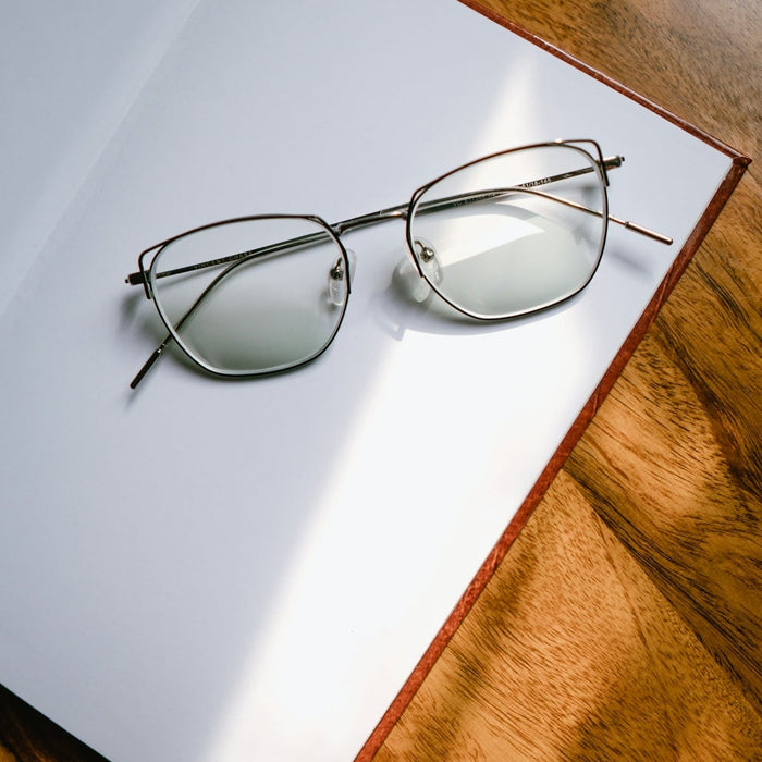 black framed eyeglasses on white table