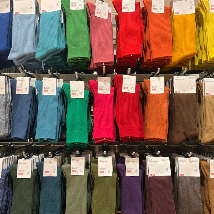A display case filled with lots of different colored socks