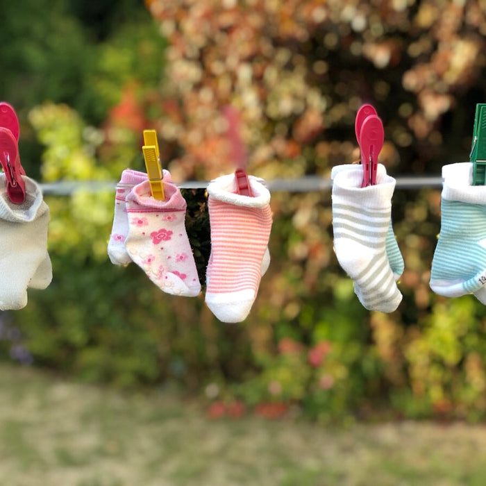 five pairs of socks pinned on clothesline