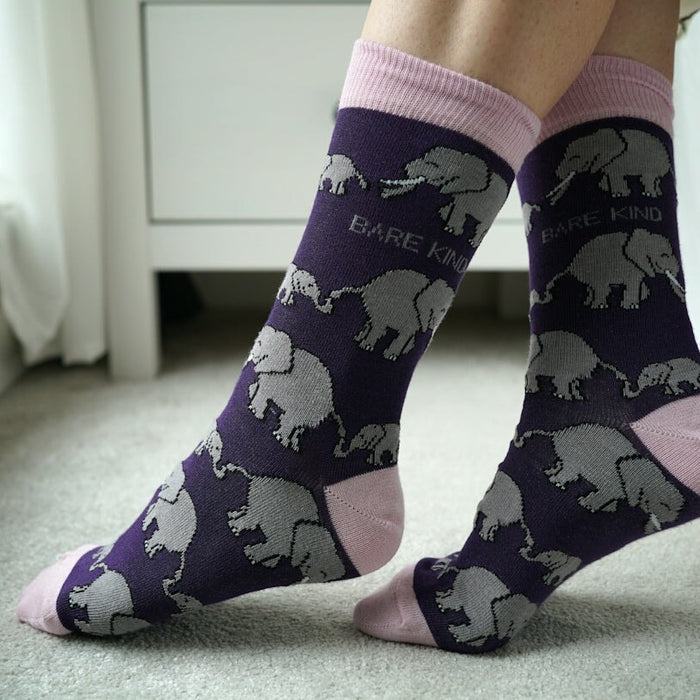 A person wearing socks with elephants on them