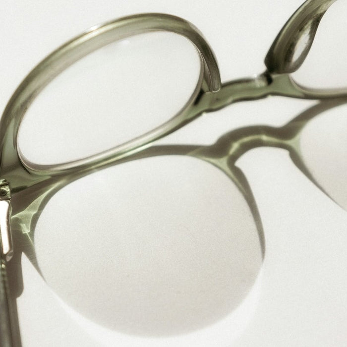 black framed eyeglasses on white surface